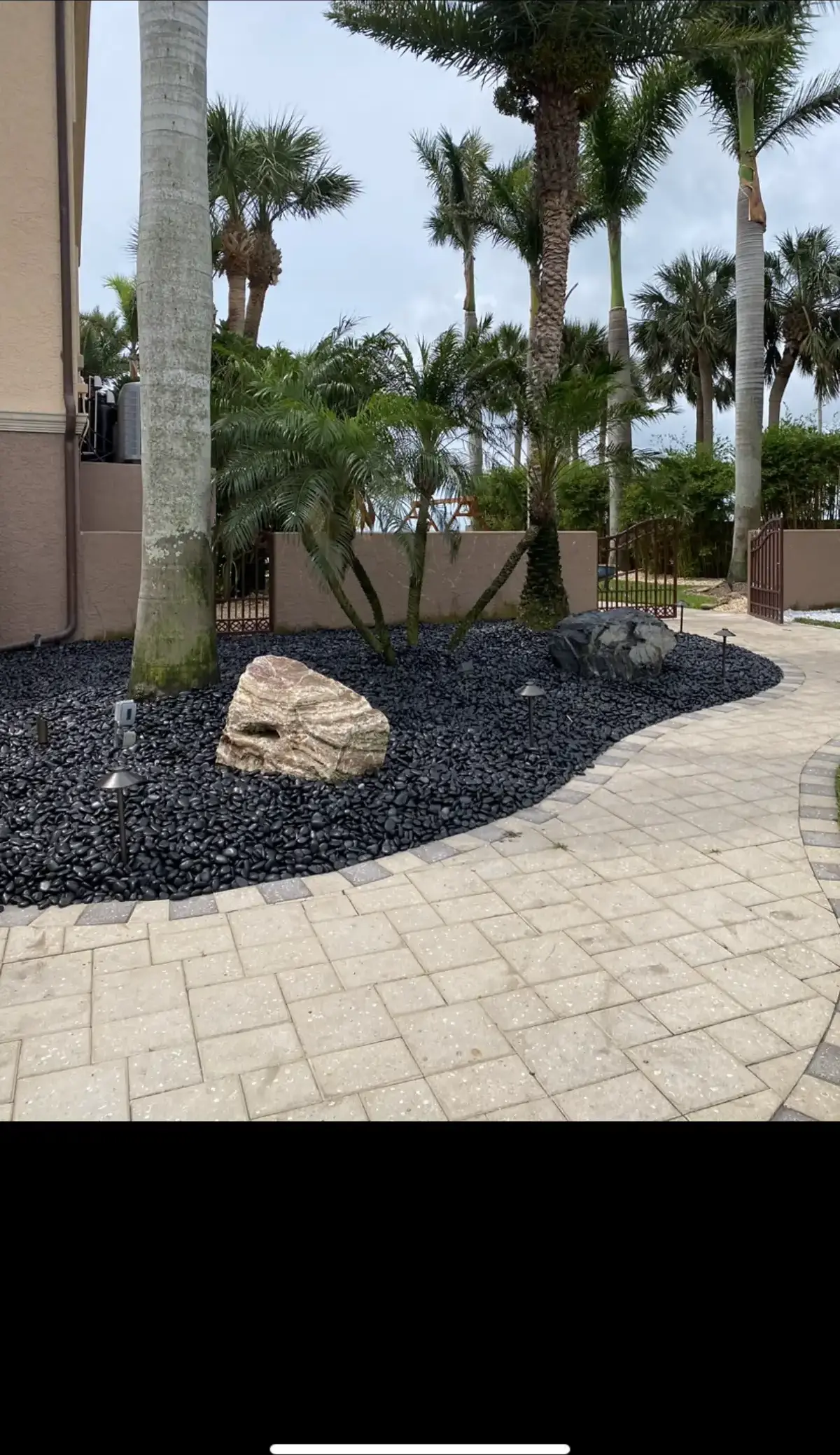 Backyard hardscaping with pavers and retaining wall in Pinellas County